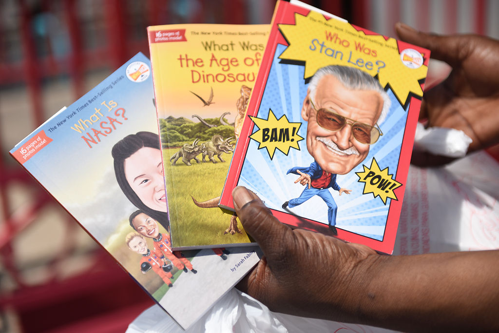 Tierra Lucas walks to her car with a selection of children’s books from Broadway Diner